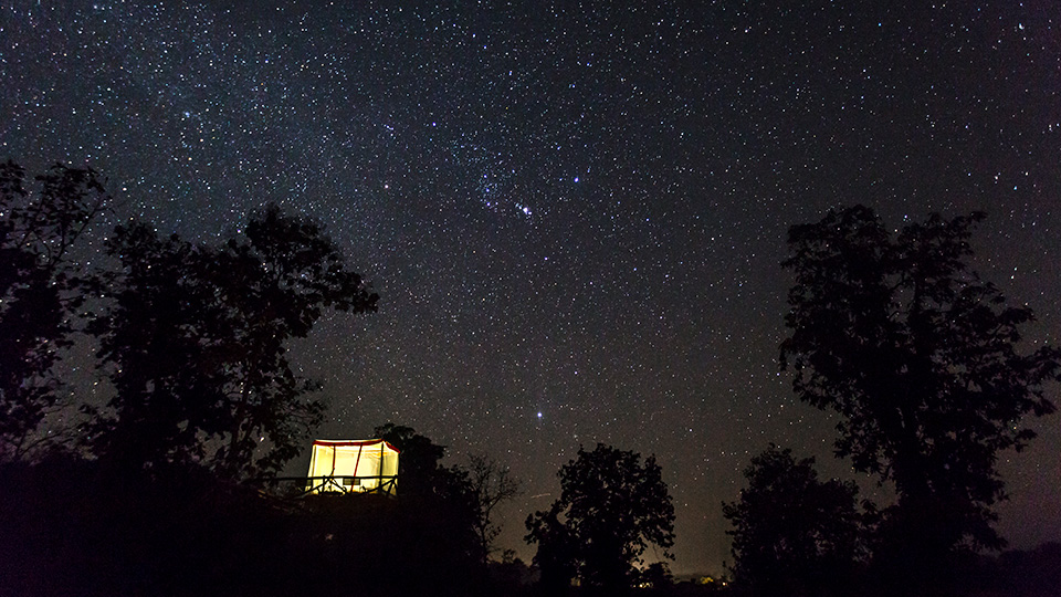 Under the night sky at the sleep out deck, Jamtara Wilderness Camp, Pench National Park, India